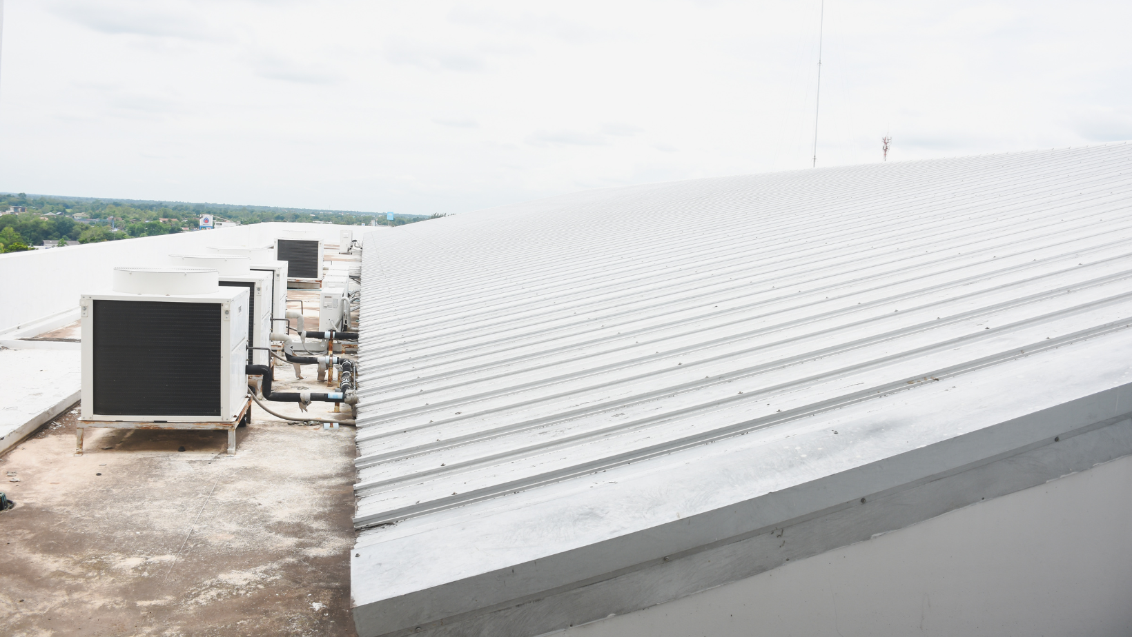 Metal rooftop with air conditioning units on a commercial building.