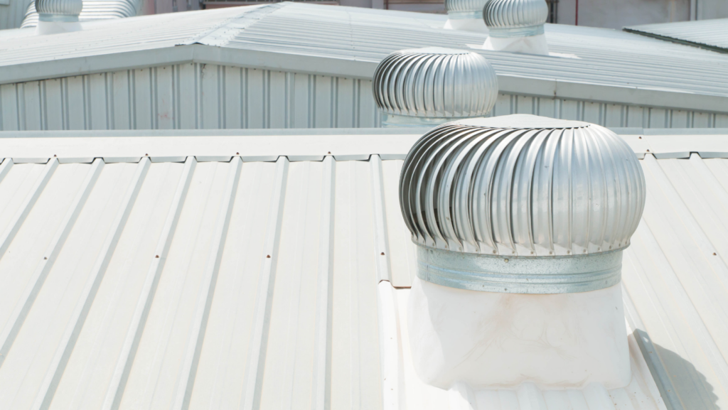 A metal roof featuring a prominent metal vent positioned at its peak, showcasing a durable and functional design.