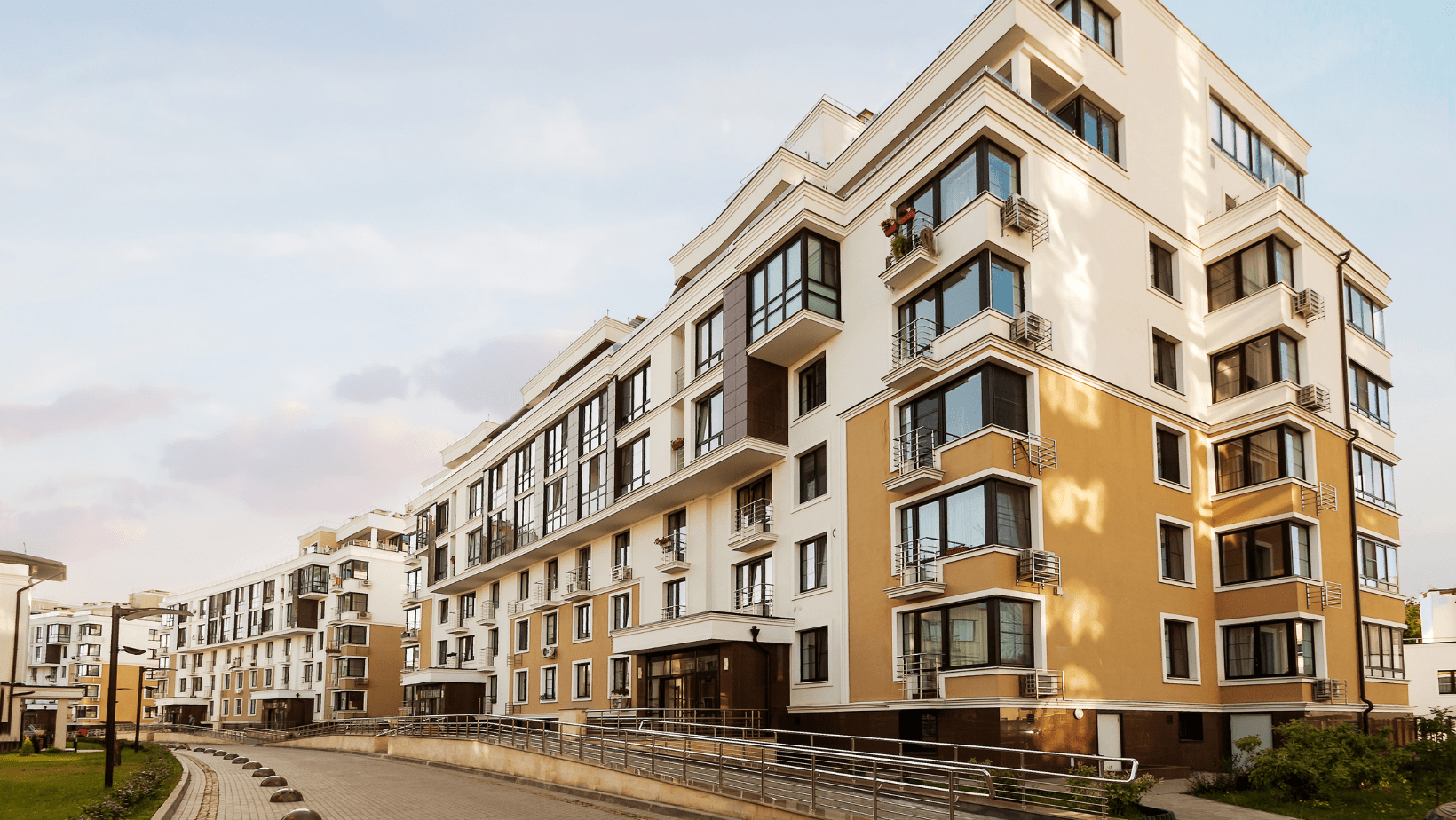 A large apartment building featuring numerous windows, showcasing a modern architectural design and urban living space.