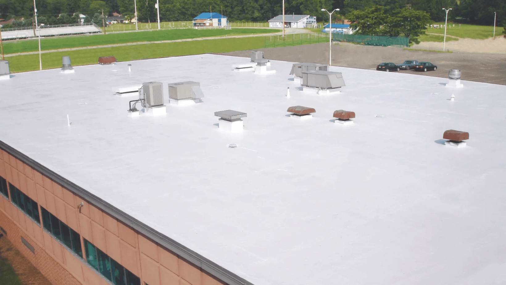 A roof covered in white paint, showcasing a clean and bright appearance against the surrounding environment.