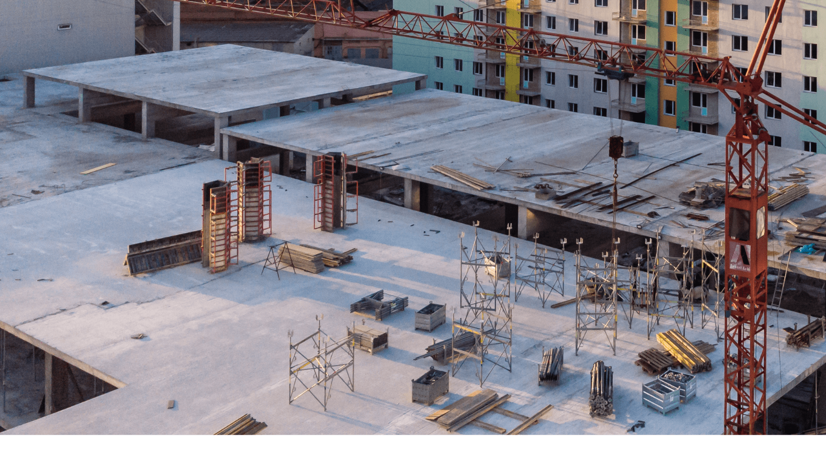 A bustling construction site featuring cranes and various construction equipment actively engaged in building activities.