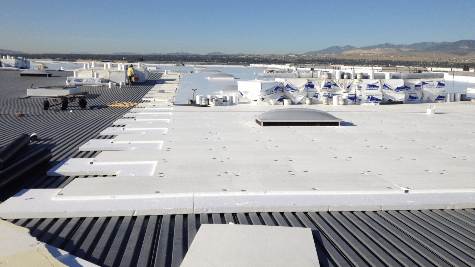 A large white roof featuring white insulation, showcasing a clean and modern architectural design.