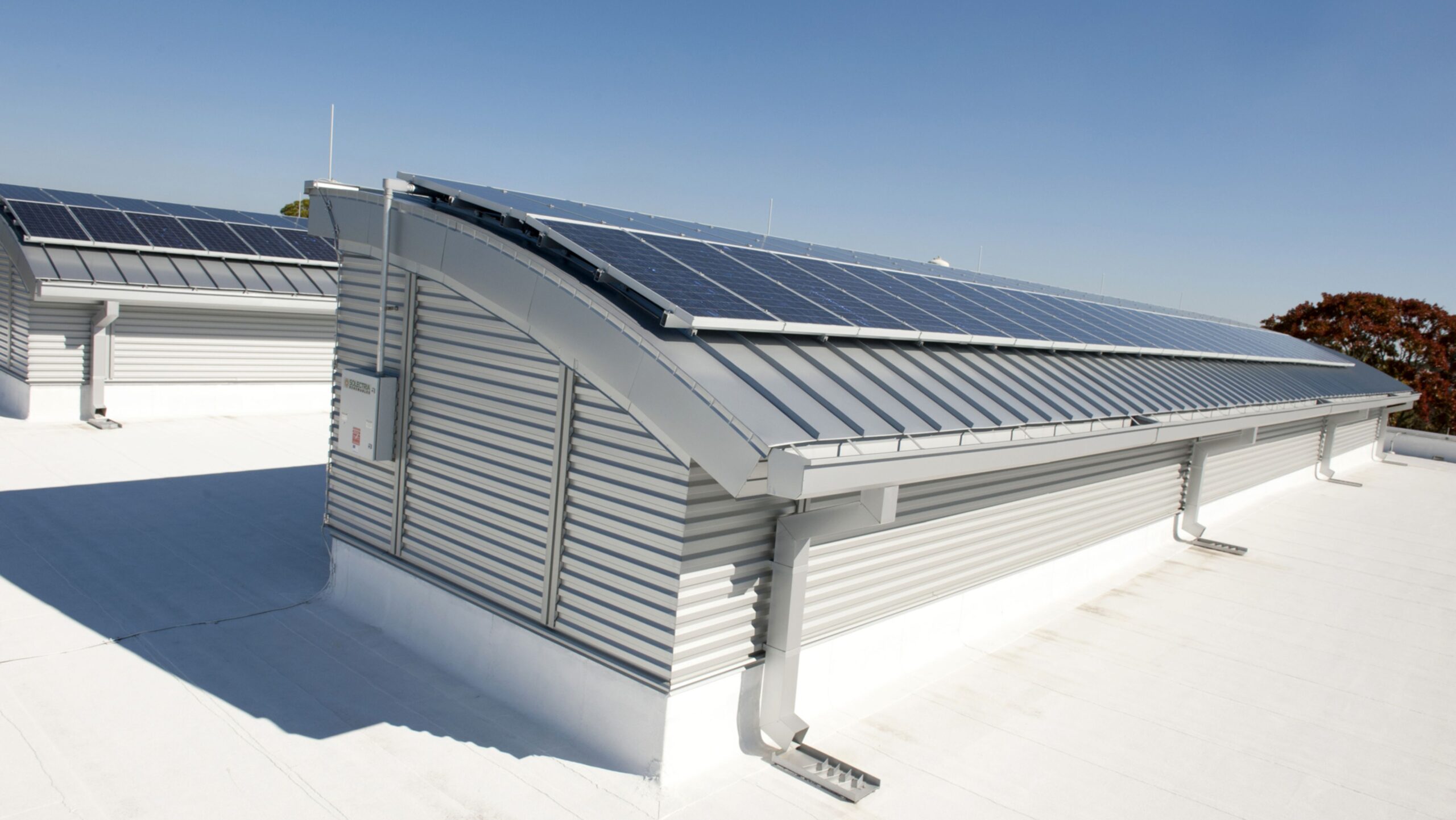 Solar panels installed on a building's roof, harnessing renewable energy from the sun for sustainable power.