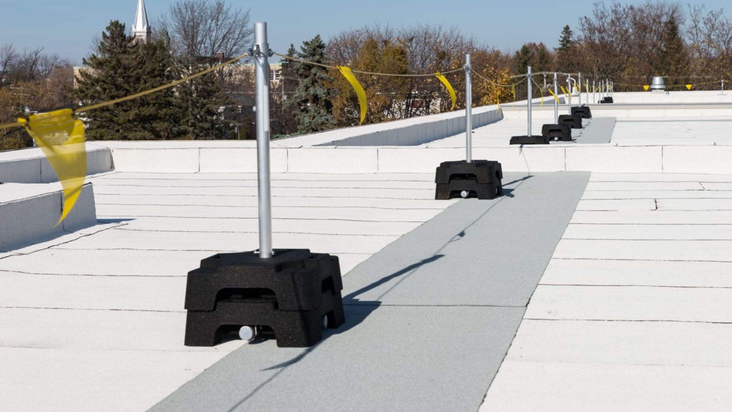 A pristine white roof covered with a white roofing membrane, emphasizing simplicity and elegance in construction.