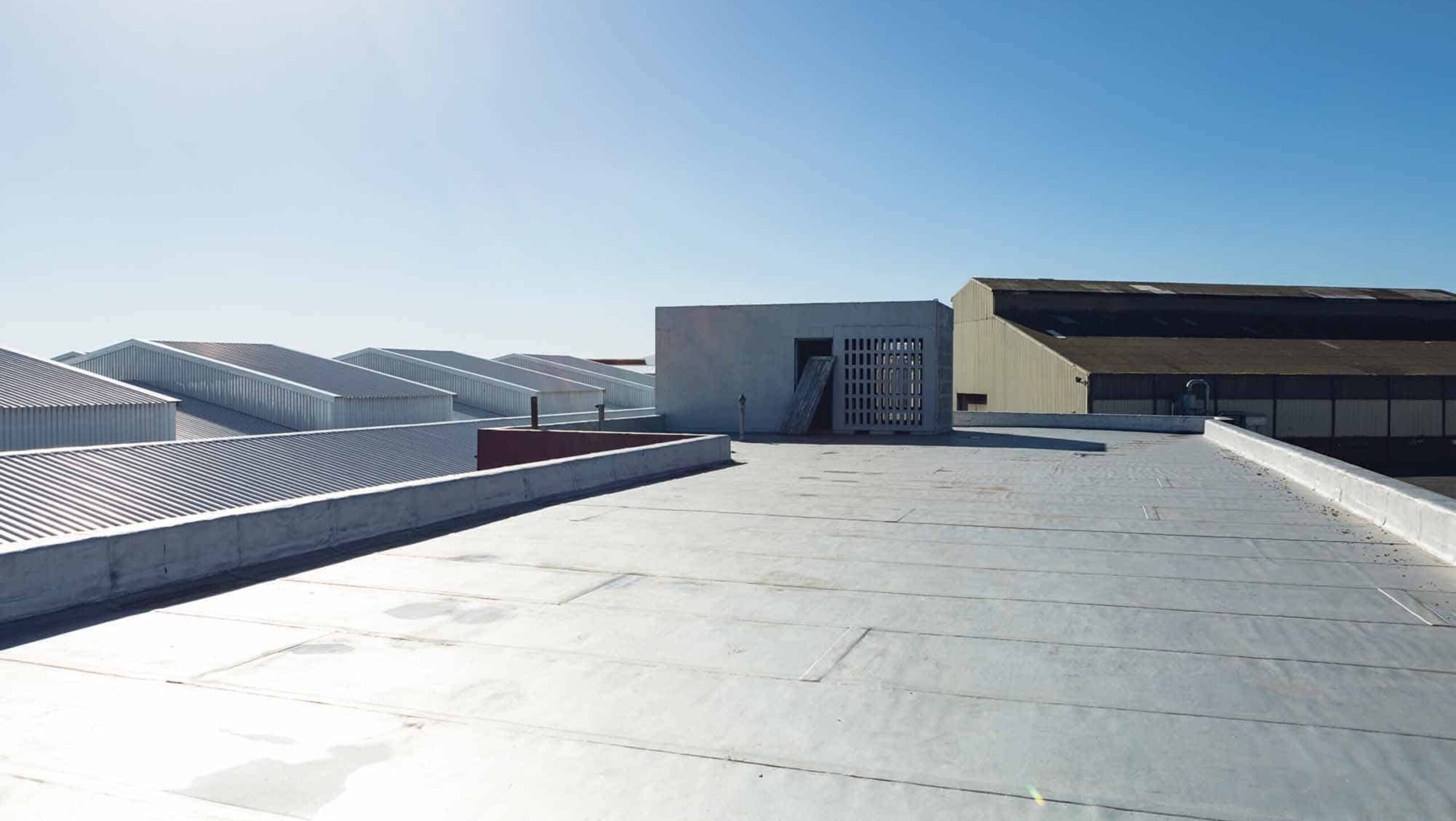 A close-up view of a building featuring a durable metal roof, showcasing its sleek design and structural integrity.