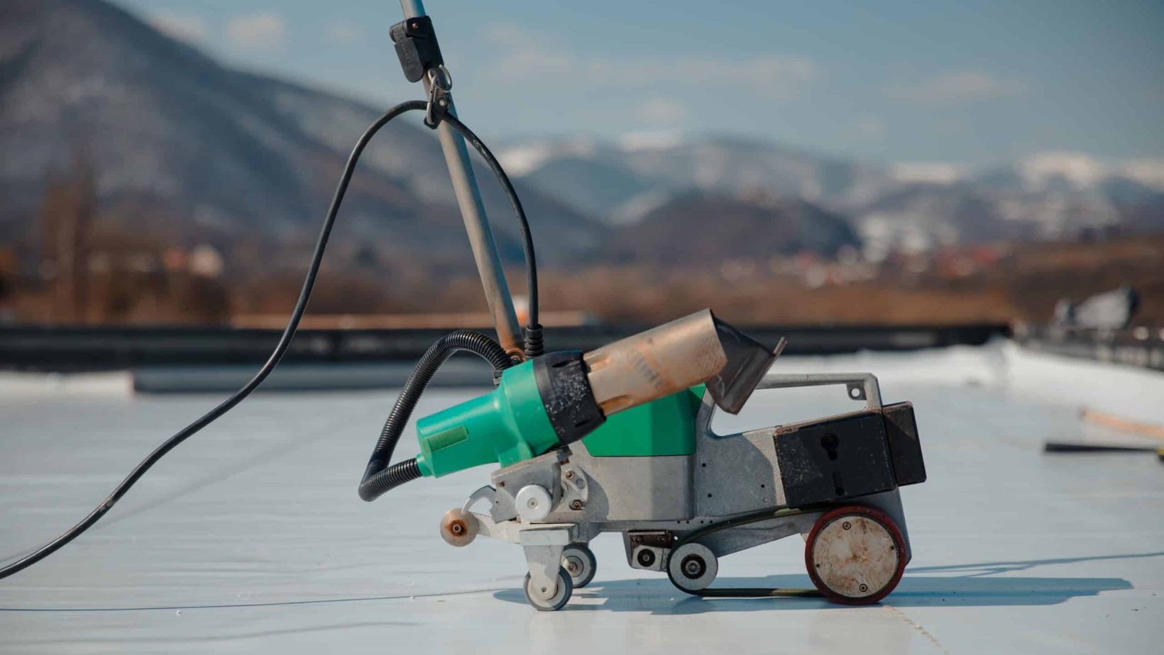 A green and white rooftop machine