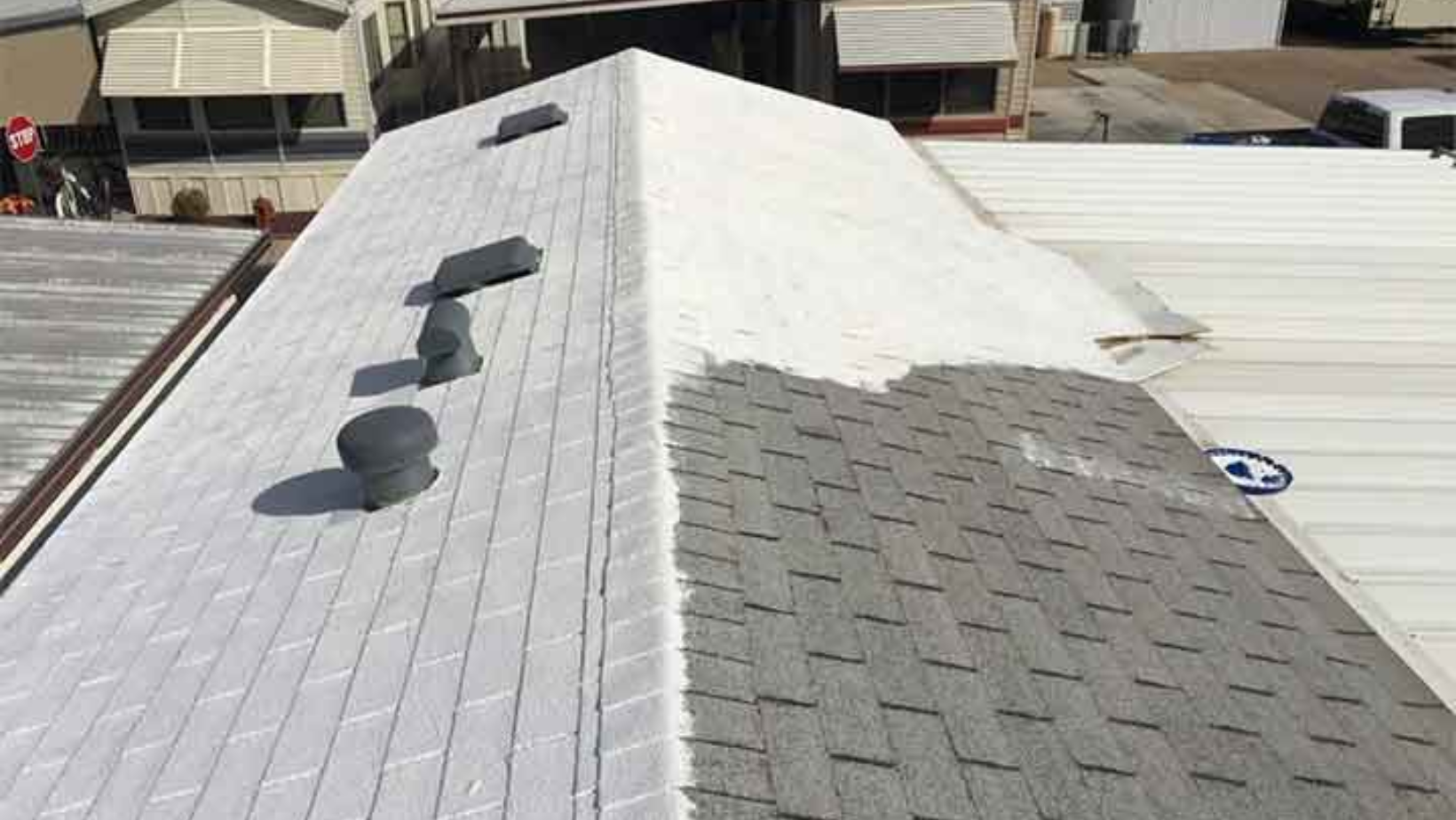 A roof featuring white shingles and a smooth white surface