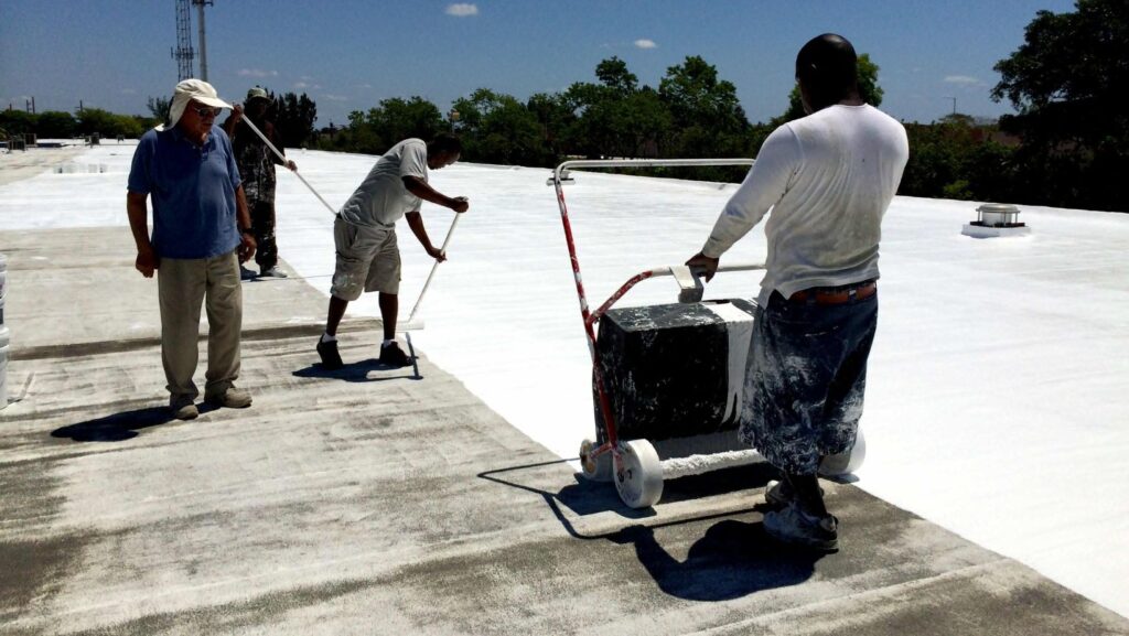 A group of men working together on a white roof
