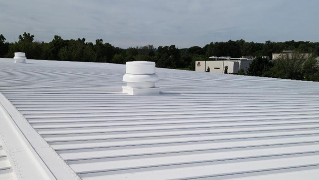 A white metal roof featuring a vent positioned at the top